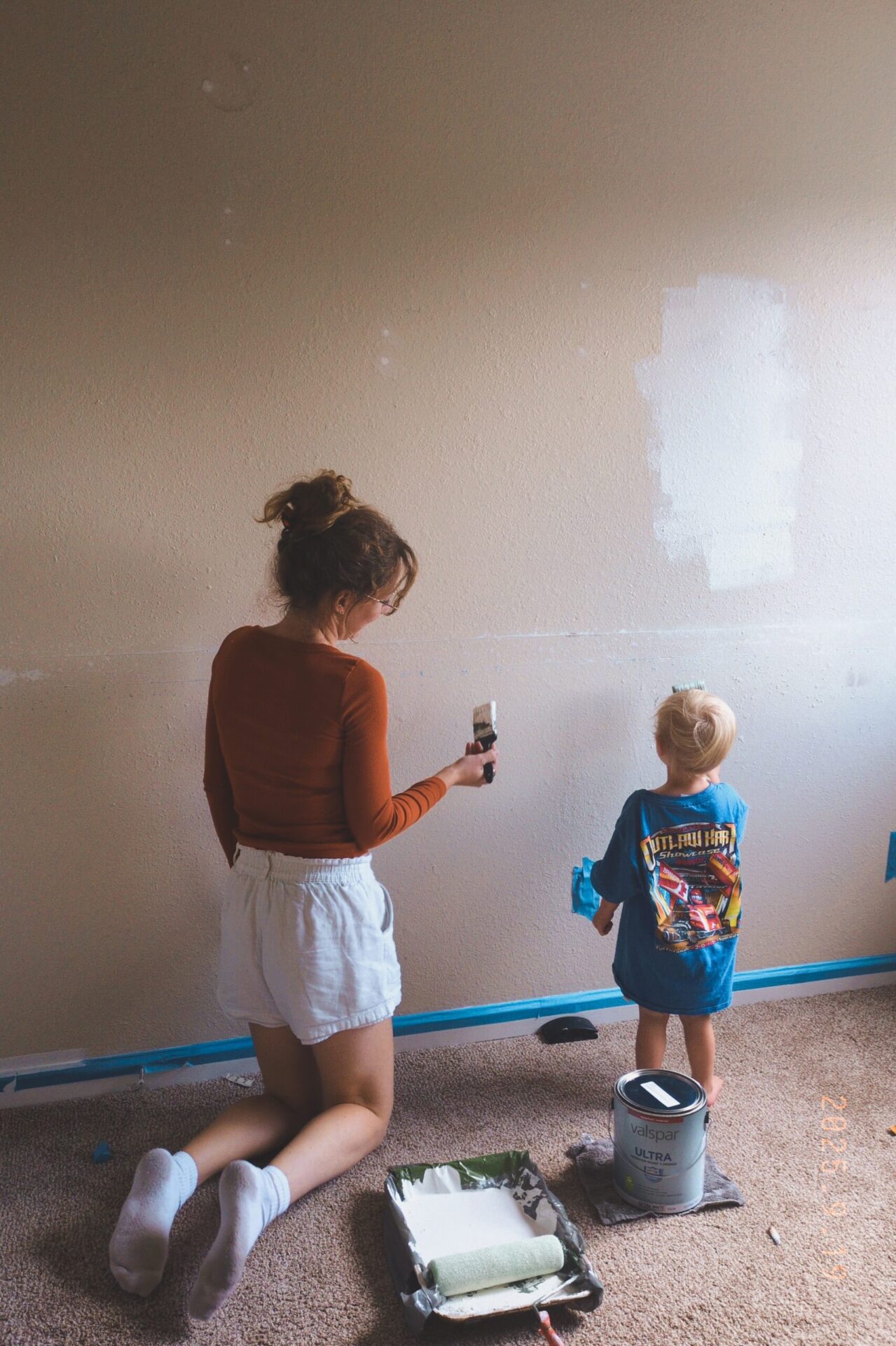 boy and mom painting bedroom